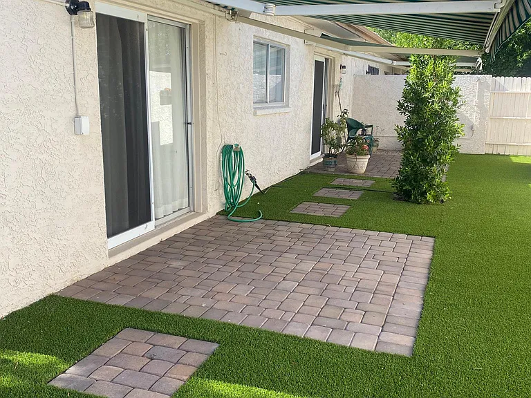 back yard; 2 awnings over patio doors from 2 bedrooms