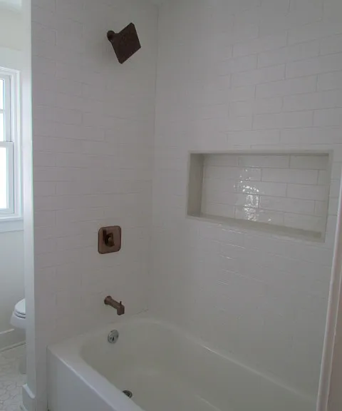 Main bath with full tiled shower/tub area