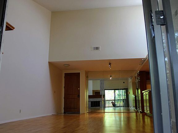 Front door entrance to unit, dining area and vaulted ceilings.