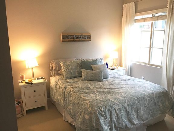 Large bedroom with room for a king bed and two windows with plenty of natural light.