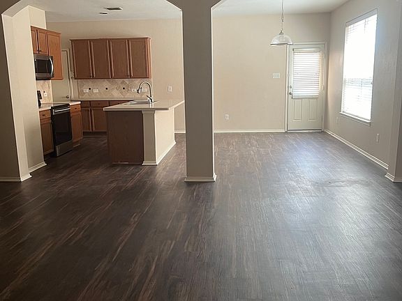 Open floor plan with living room flowing with dining room and kitchen.