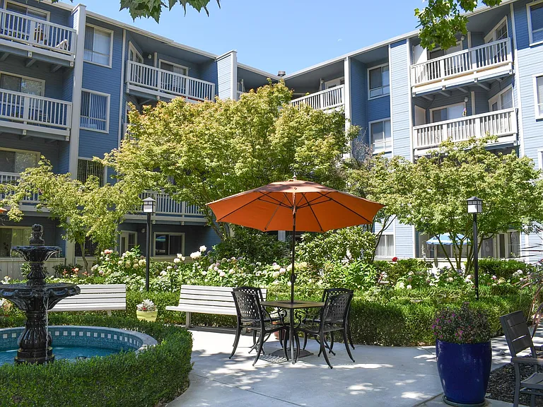 Bright and Inviting: Enjoy our peaceful courtyard, featuring lush trees, a serene fountain, and spaces perfect for activities and outdoor dining.