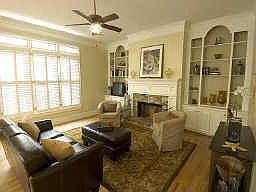 Large Family Room With Custom Cabinetry And Stack Stone Fireplace