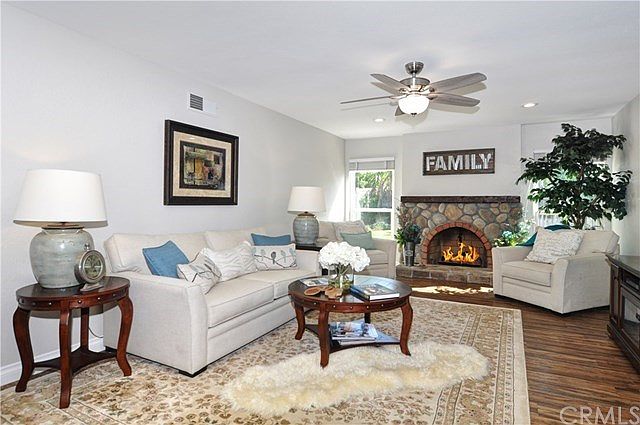 Spacious Great Room featuring recessed lighting, ceiling fan, fireplace and loads of room for family to gather together.