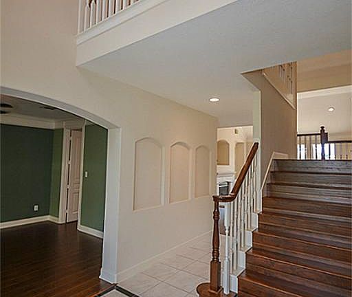The dual staircase is accessible from the entry way or from the den/kitchen area.