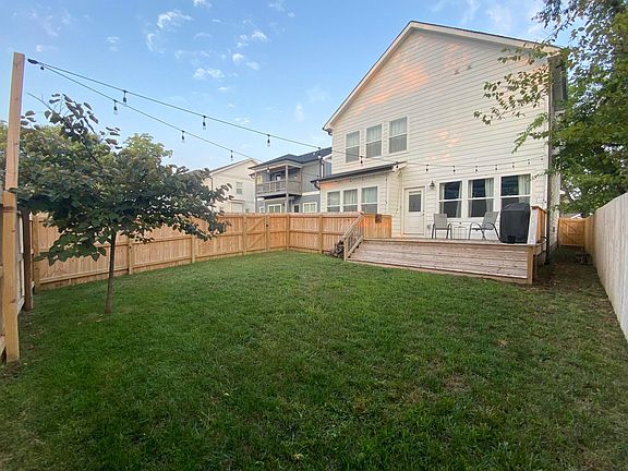 Fenced in backyard with deck
