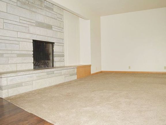 The living room is large and open with a fireplace.