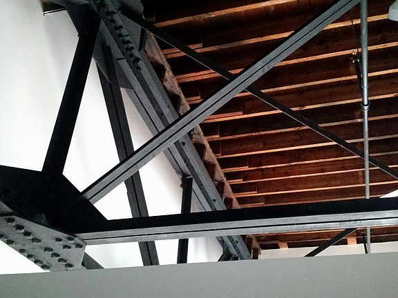 Extra high loft ceilings with exposed steel beams.