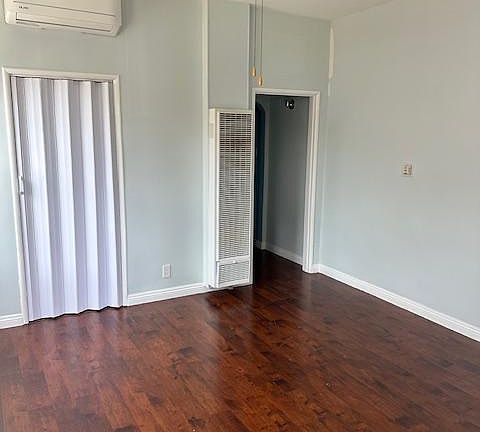 Living Room looking into Hallway and Split Unit AC and Laundry Room