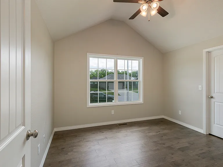 Vaulted ceiling bedroom with ceiling fan