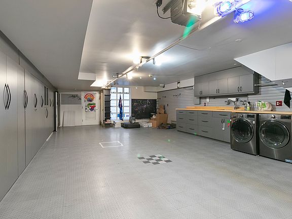 Three car parking, garage cabinets, EV charger, and laundry.
