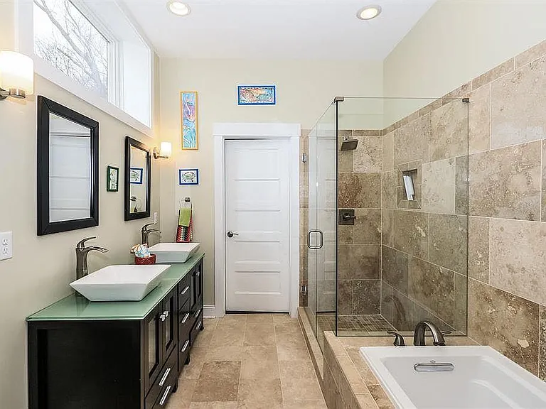 Second Floor main bedroom suite with walk- in shower, tub, double sinks, walk-in closet and laundry.