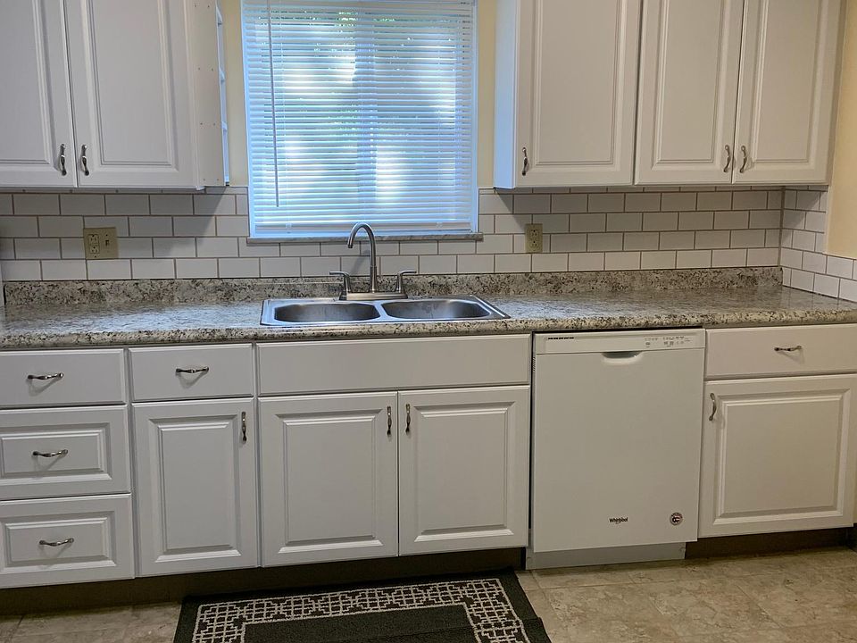Recently installed kitchen wall and base cabinets, a very appealing new countertop, gorgeous tile backsplash with coordinating tile grout