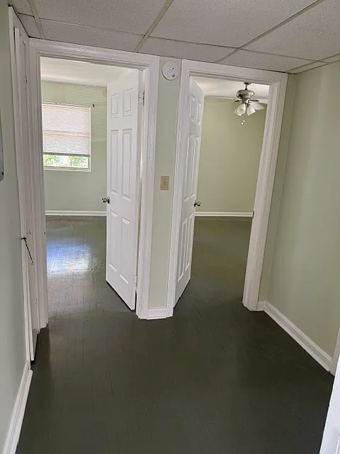 hallway with pantry showing entrance to 2 bedrooms