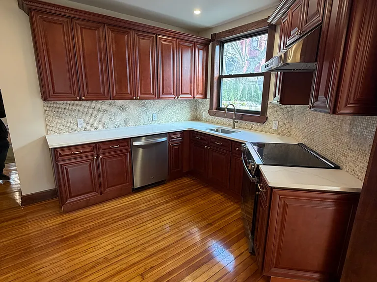 kitchen-stainless steel appliances, quartz countertop, vented exhaust hood, marble backsplash, dishwasher