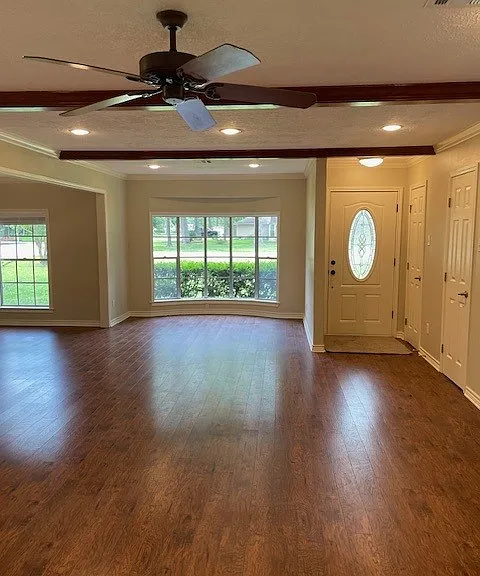 Family room toward front of house with large bay window.