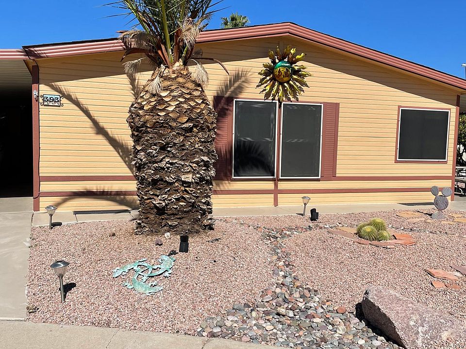 Front view with carport on left and a patio on right.
