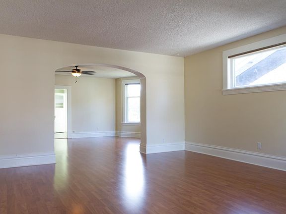 View from entry into living room and through archway to dini