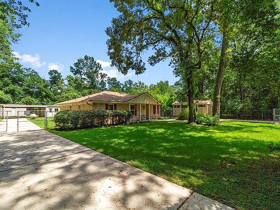 Huge side driveway with shop and 2nd covered carport.