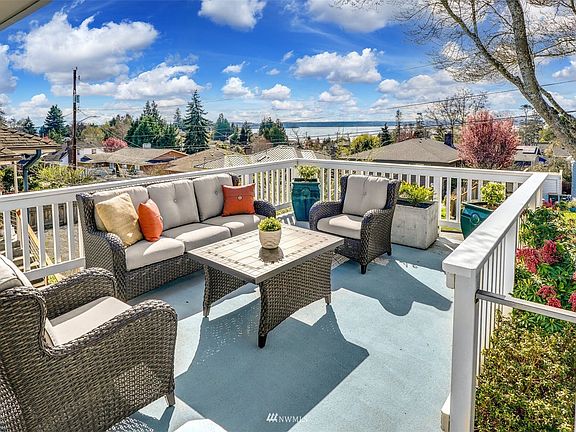 Spacious western facing deck off living room and entry with sweeping sound and mountain views.