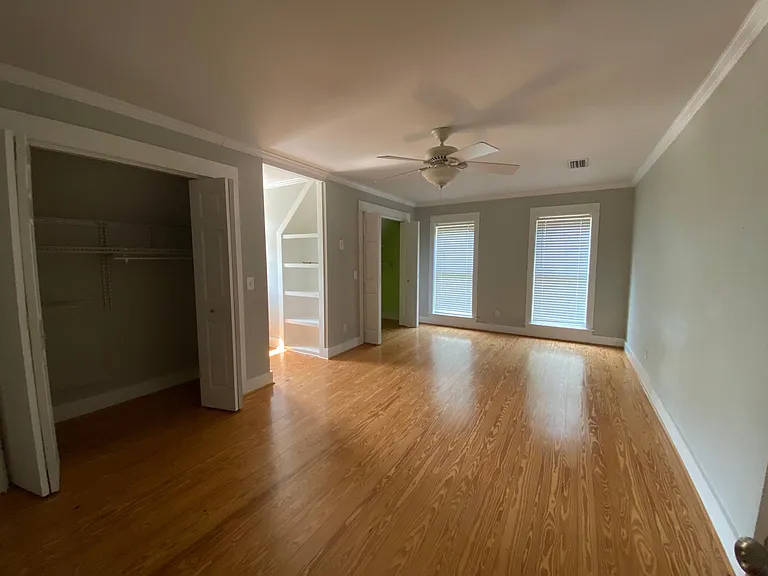 Upstairs bedroom number two, two closets, bookshelves, reading nook, floor to ceiling windows.