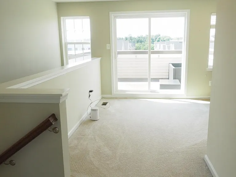 The top floor opens to a family room and rooftop deck.