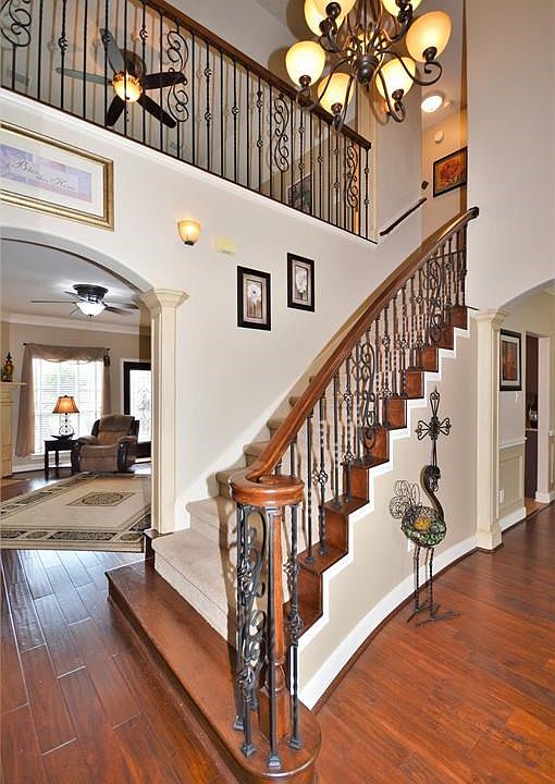Towering ceilings, gleaming real Hardwood Flooring and an elegantly curved staircase greet guests. Beautiful updated chandelier and notice the updated millwork/columns!