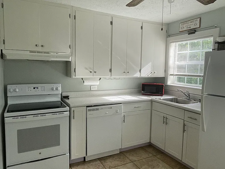 Kitchen - all electric, with smooth top stove, dishwasher, refrigerator with ice maker. Ceramic floors with natural sunlight.