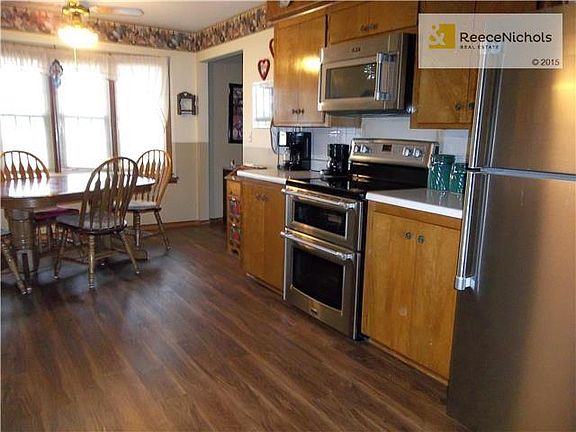 Eat-in Kitchen with wood looking laminate flooring.