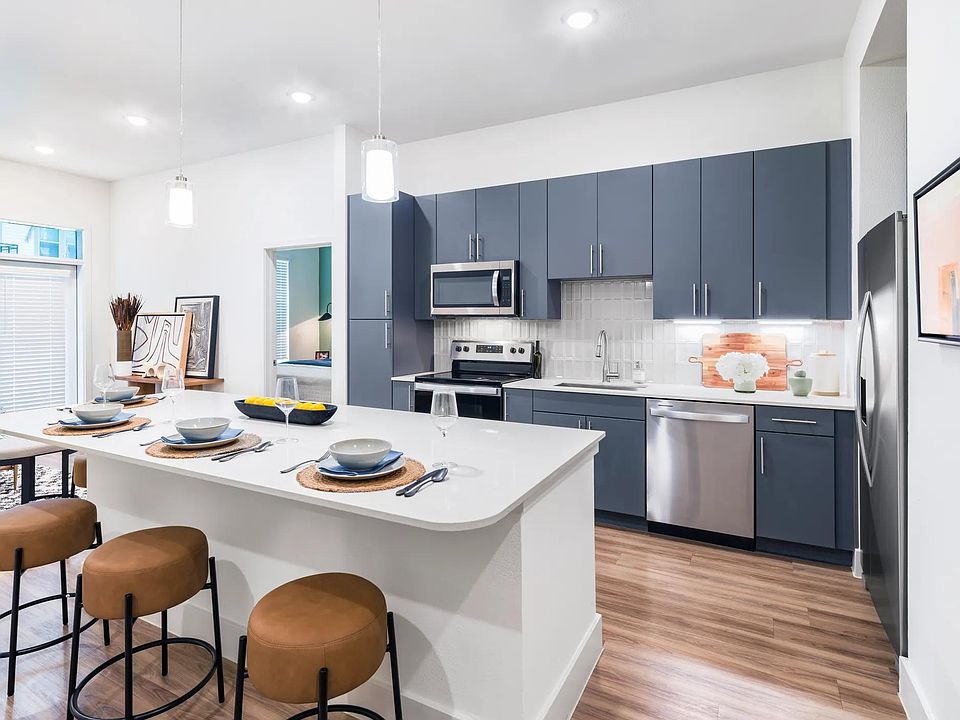 Indulge in culinary delights within Modera Garden Oaks'' gourmet kitchens, highlighted by quartz countertops and custom 42-inch cabinetry featuring under-cabinet lighting for both style and practicality.