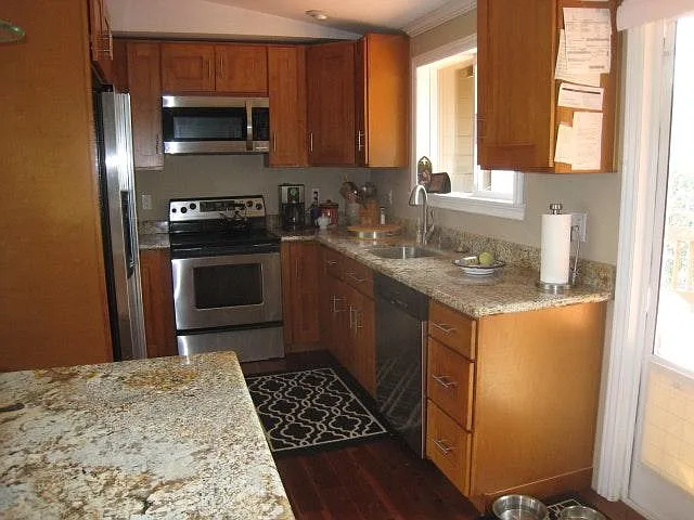 Remodeled kitchen with new cherry cabinets and slab granite