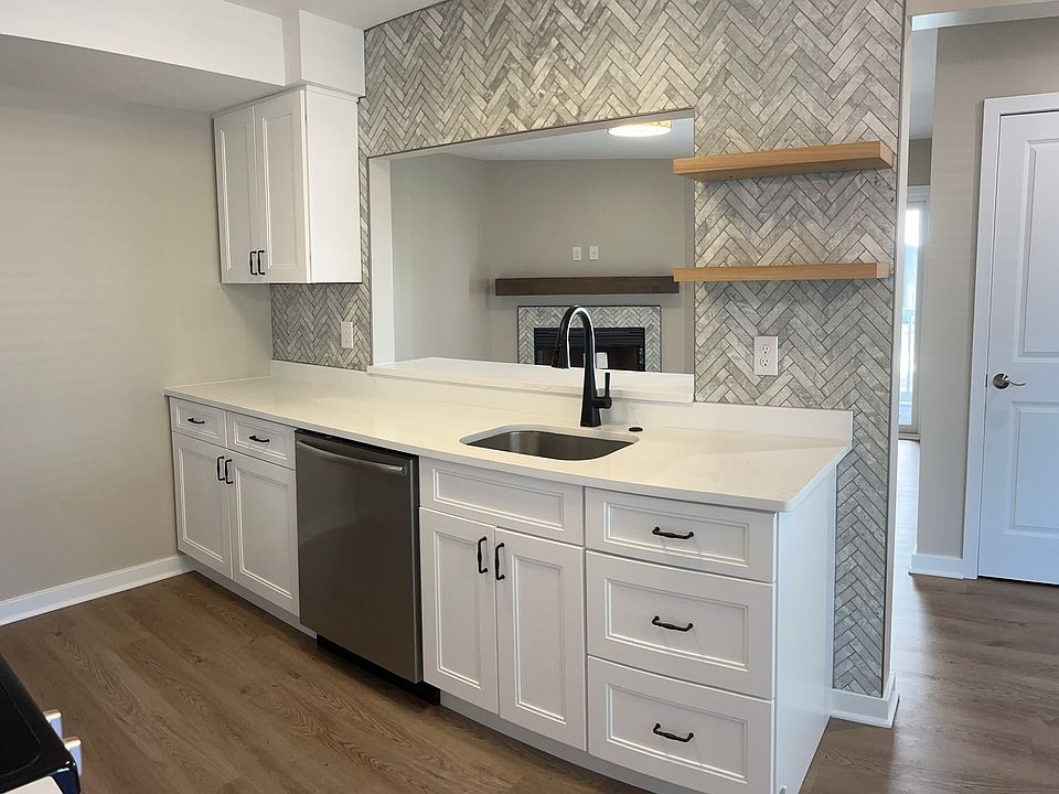 Beautiful herringbone backsplash and floating shelves.