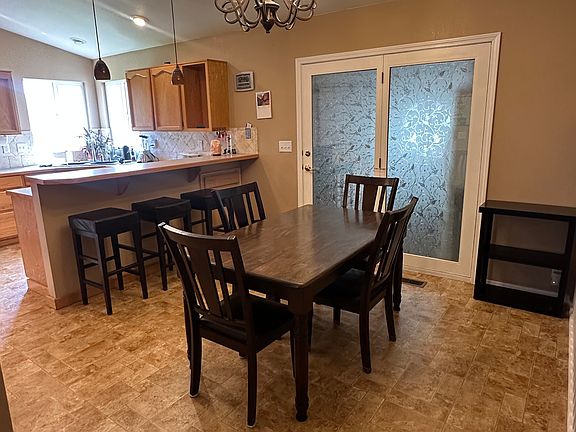 Dining and kitchen. Backdoor leads to the bonus room and outside.