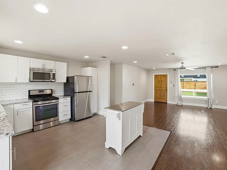 Kitchen (with floating island, movable) looking toward living room and front door