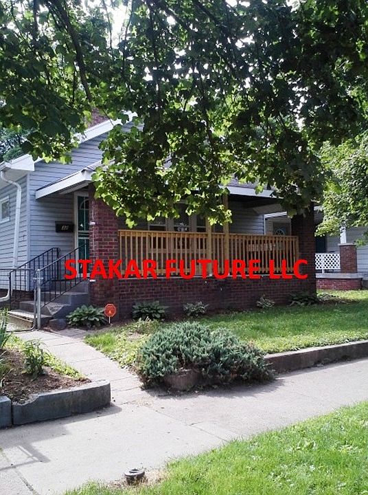 a summer photo showing landscape and nice front porch