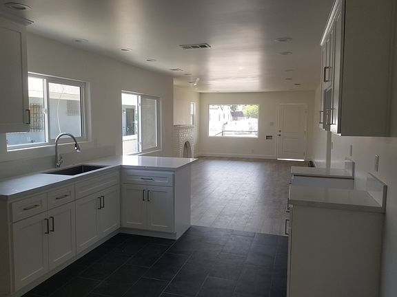 Kitchen with new white cabinets and quartz counter tops.