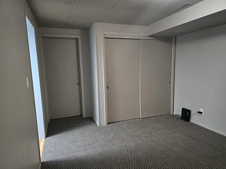Bedroom has full-size closet. Door on left is always locked, leads to furnace room. Ok to put personal things in that nook.