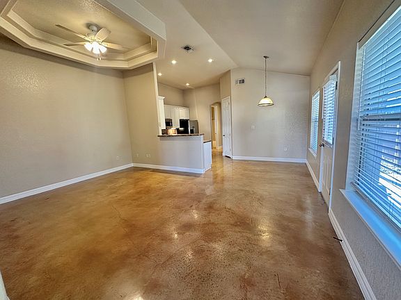 Living, kitchen, and dining are open and airy with lots of natural light.