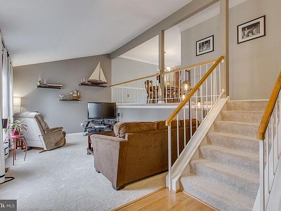 Split foyer entry with hardwoods opens to LR