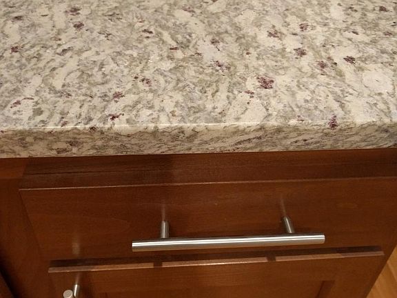 Granite counter tops and stainless steel cabinet hardware