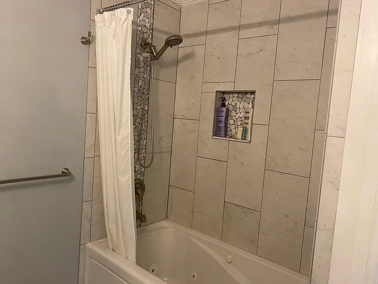 Whirpool tub and shower in guest bathroom.