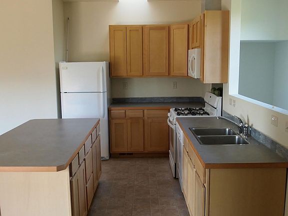 Kitchen skylight, island with storage and bar for stools. Plenty of cabinets!