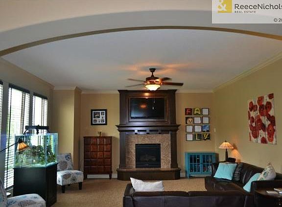 Great Room with arched entry and wall of windows.