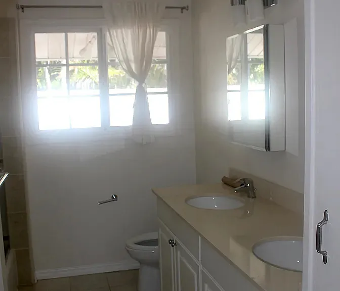 Hallway full bath with two sinks