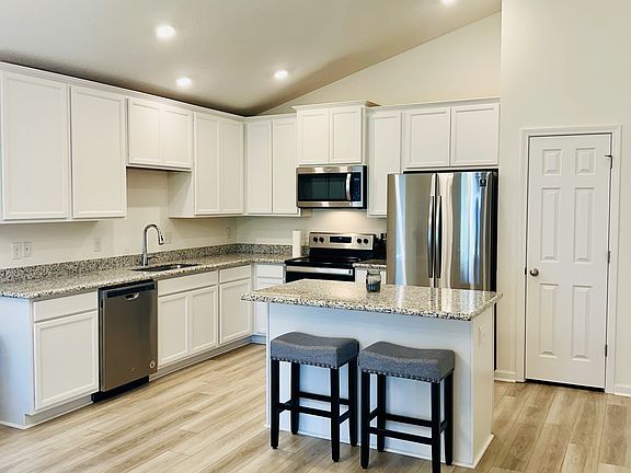 Beautiful kitchen with stainless steel appliances, open concept, pantry, and island!
