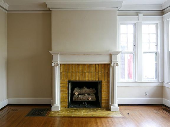 Living room fireplace - note the custom finishes and crown m