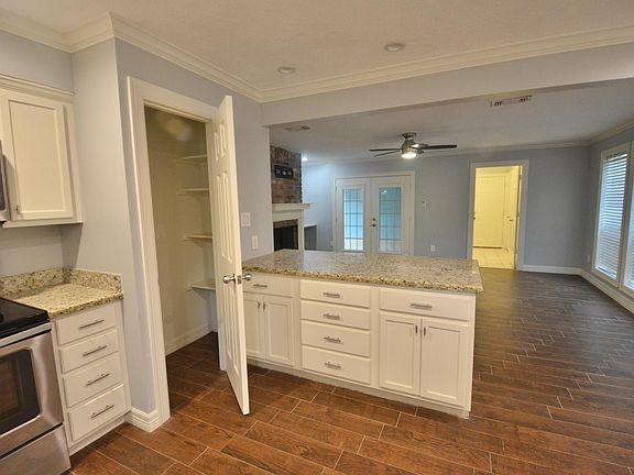 Pantry and breakfast bar with view toward family room and laundry room/half bath.