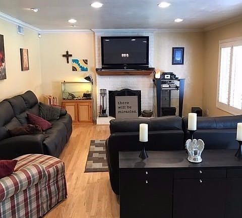 An attractive fireplace and lots of windows add to the appeal of the living room...