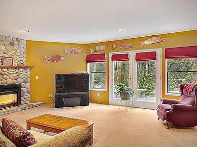 Family room with a river rock fireplace