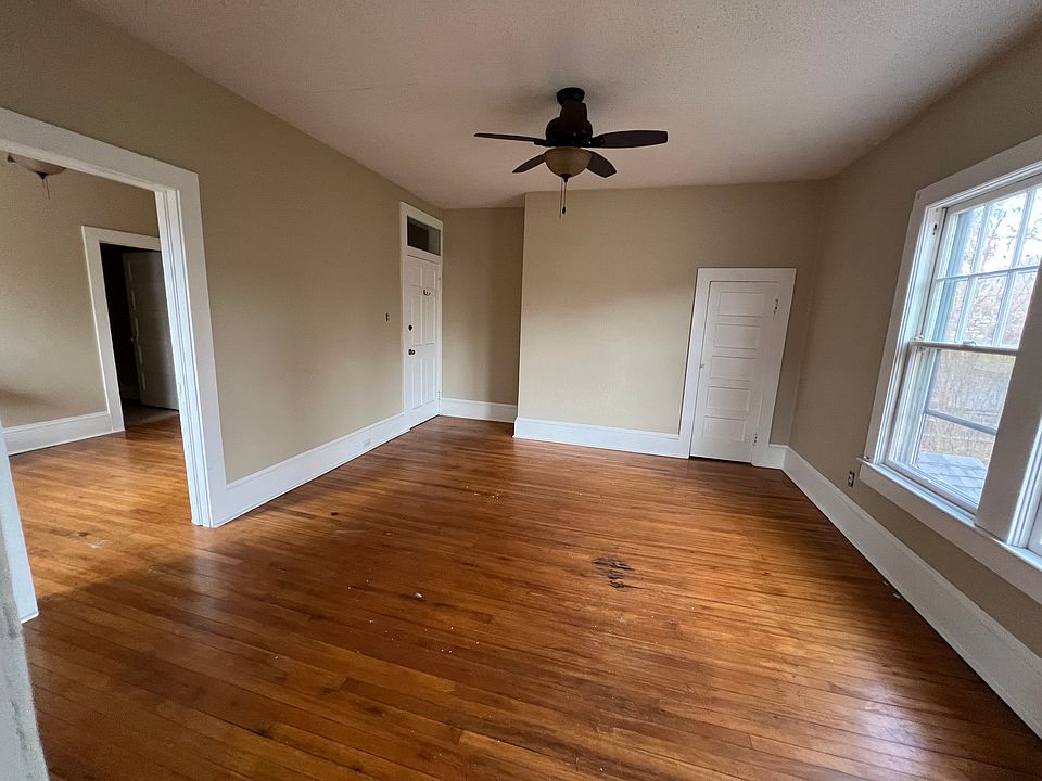 Another look at the main living area with entry door in the rear center and door to a small closet on right